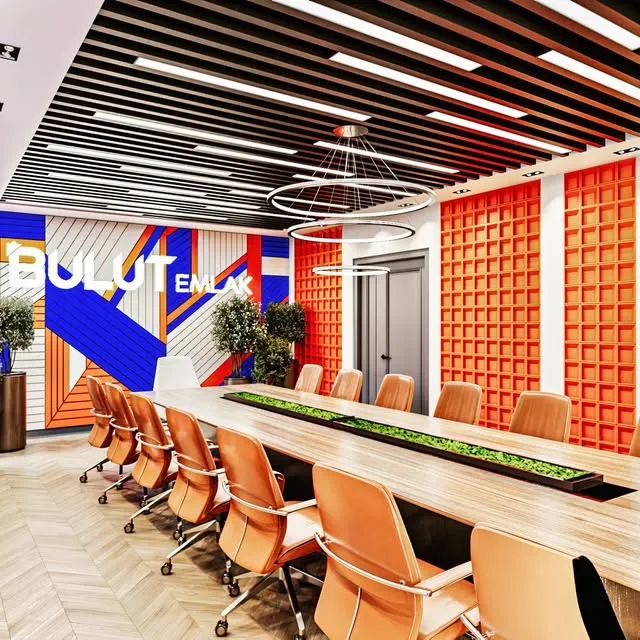 Lineer aydınlatmalı ahşap tavan ve turuncu duvar panelleriyle ofis toplantı salonu